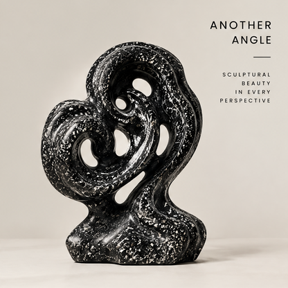 Alternate full view of the black double swirl sculpture showing curved loops and multiple openings