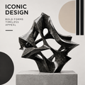 CELORM black geometric stone sculpture with pointed planes, sweeping curves, and openwork cutouts