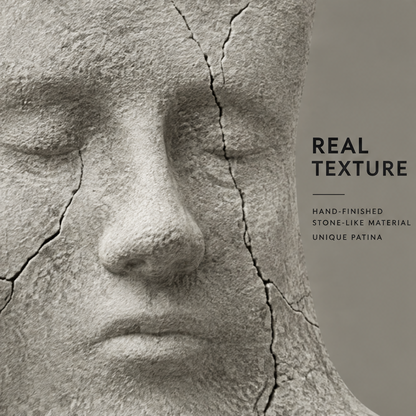 Close-up of the sculpted face with rough stone-like texture and visible crack-like lines