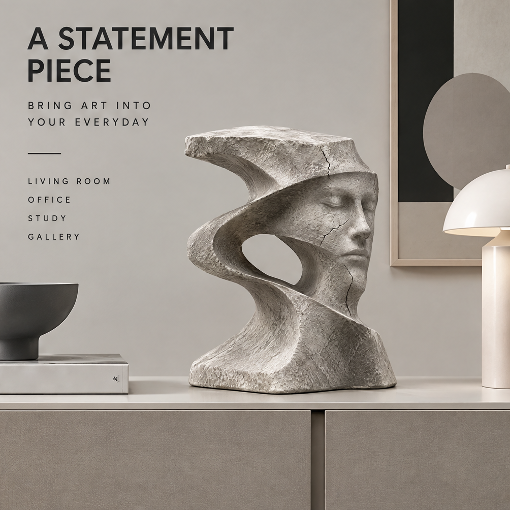 Spiral face sculpture styled on a console beside books, a black bowl, a lamp, and framed art